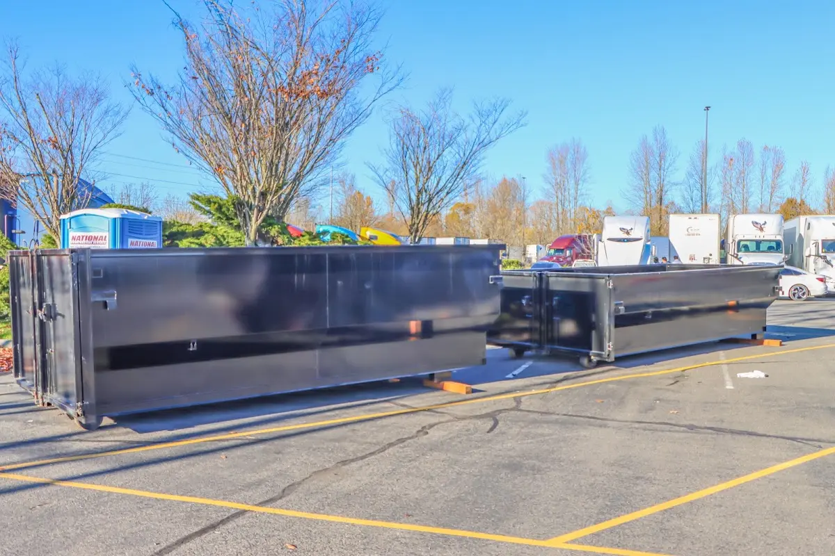 Professional dumpster rental service with roll-off container on residential driveway in Sweet Home